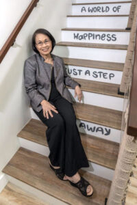 Jerri Chong, president of Ronald McDonald House Charities Hawaii, sits on the stairs of the newly renovated family recreation center in the Judd Hillside house.EUGENE TANNER | PBN